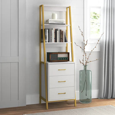 White bookshelf with gold accents against a white wall with a window.