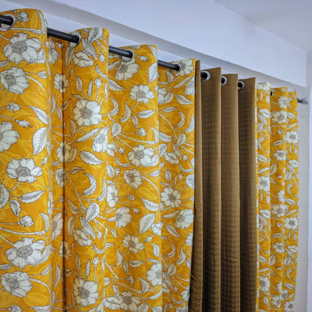 Yellow floral curtains with a plain white background