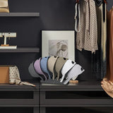 Set of colorful hats displayed on a stand with a dark background