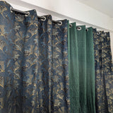 Curtains with floral pattern and plain green curtain side by side.