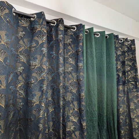 Curtains with floral pattern and plain green curtain side by side.