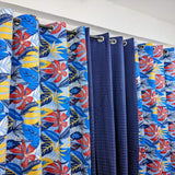 Curtains with colorful floral patterns hanging on a rack.