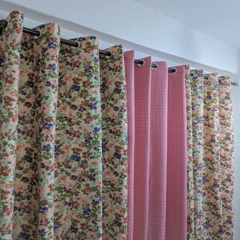 Curtains with floral patterns on a white wall