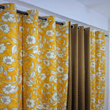 Yellow floral curtains with a plain white background