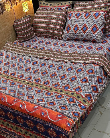 Decorative bedspread with geometric pattern on a bed in a room.